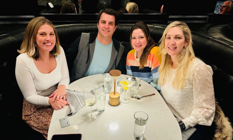 Four members of our Onward Accessibility team sitting at a table having dinner.